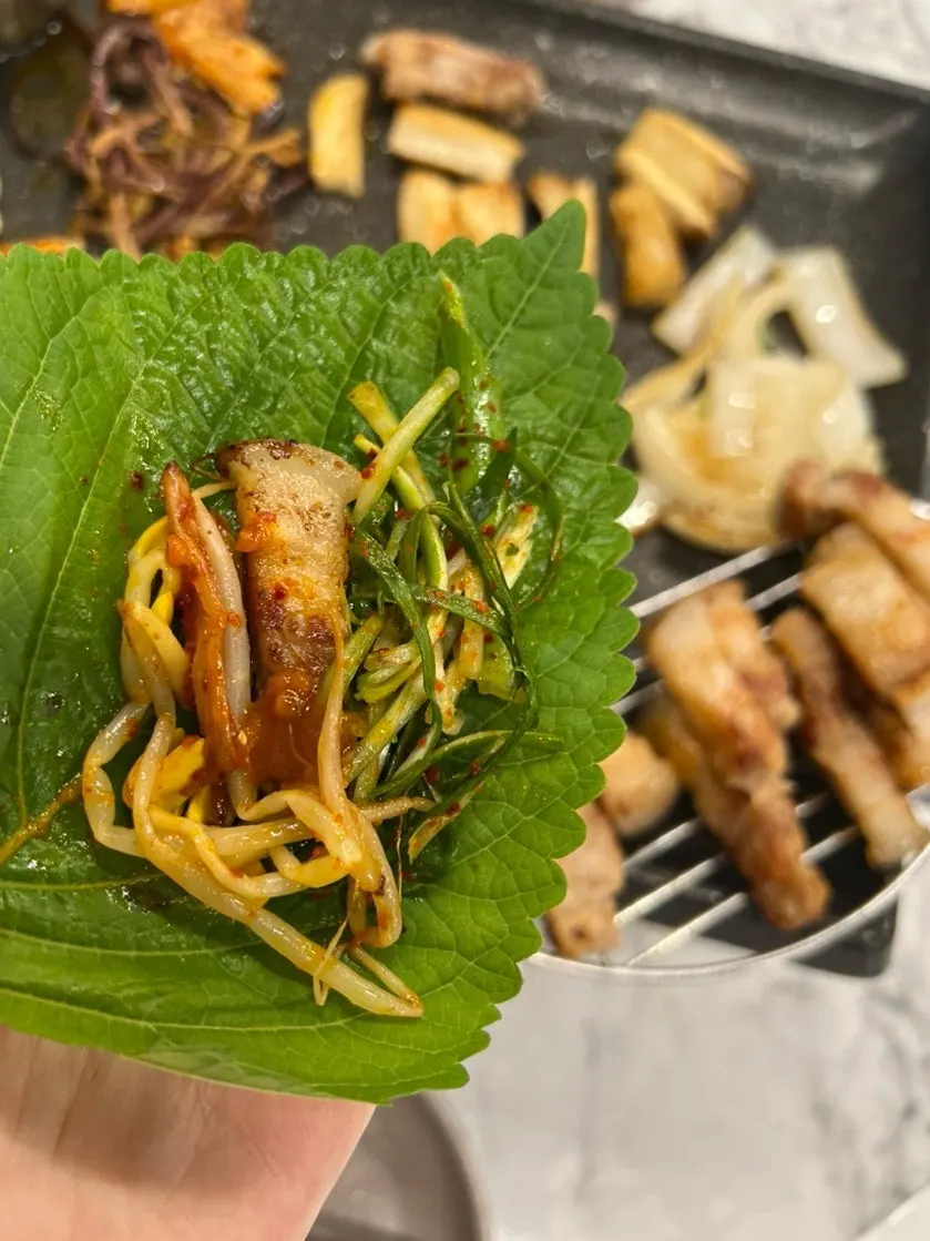 A lettuce wrap bite with grilled meat