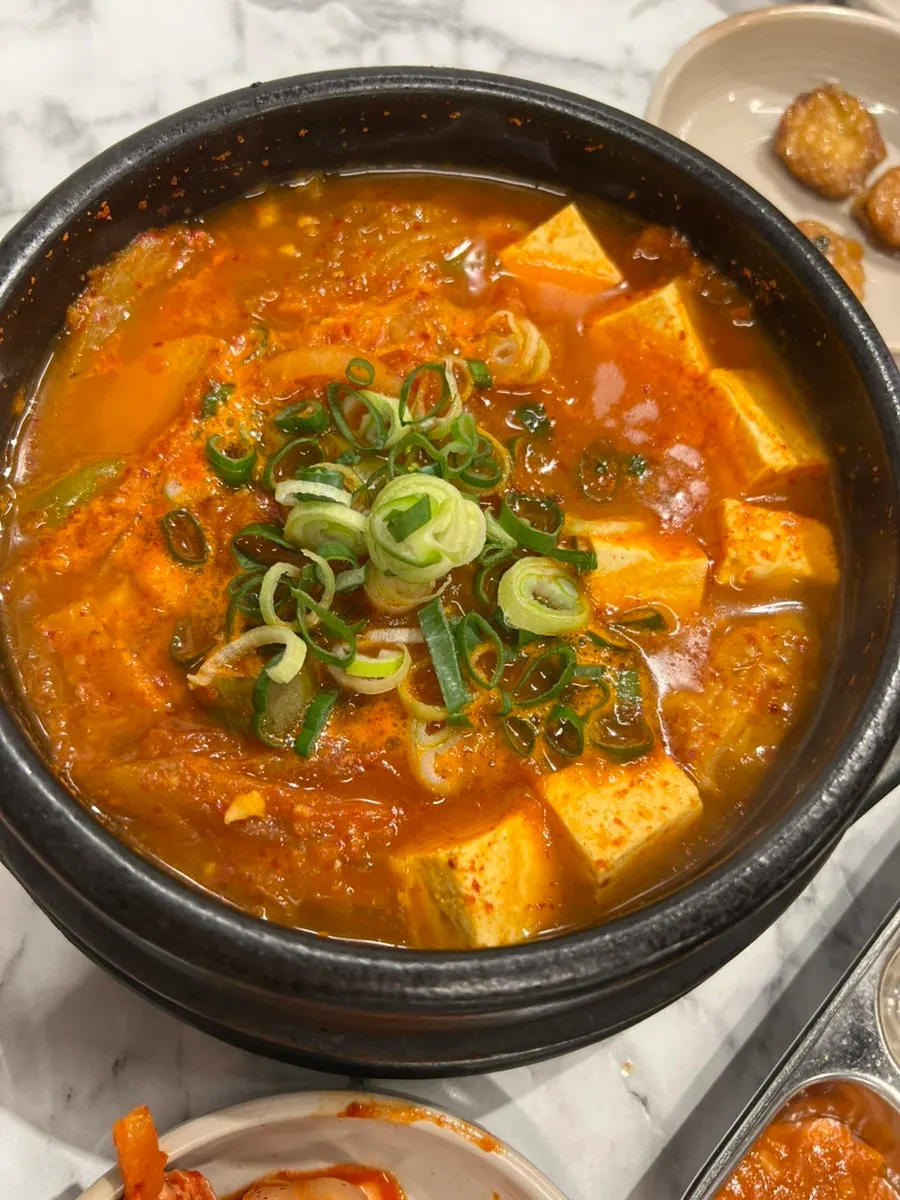 Black pork kimchi jjigae simmering