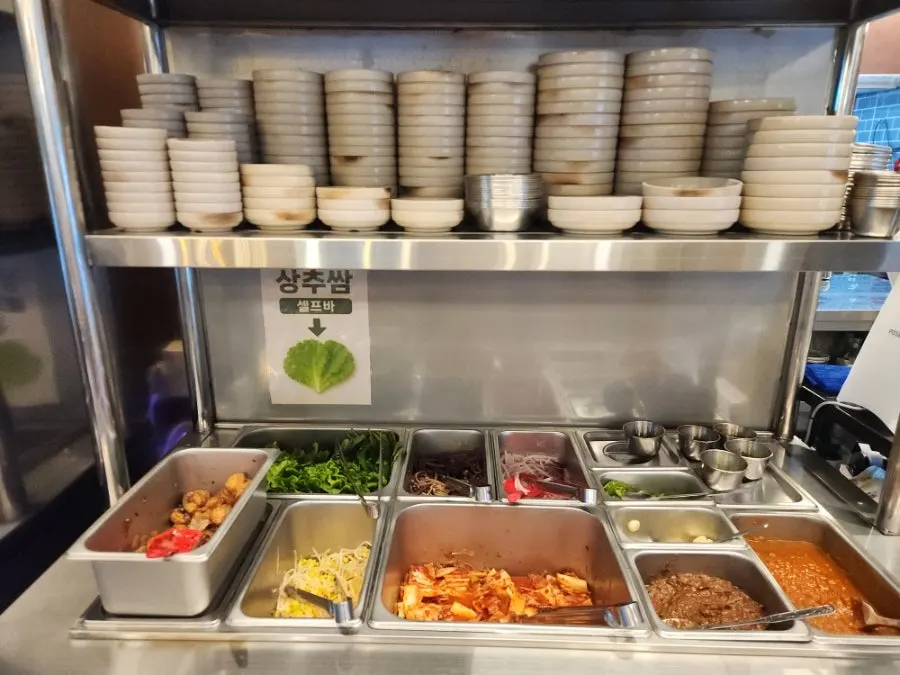 Self-serve bar with kimchi, bracken fern, and myeoljeot
