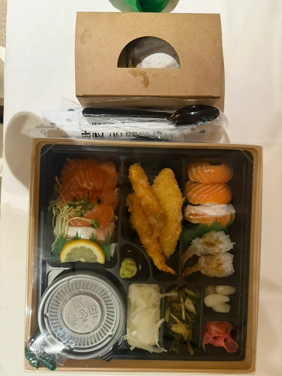 Lunchbox spread with mackerel sashimi on the side
