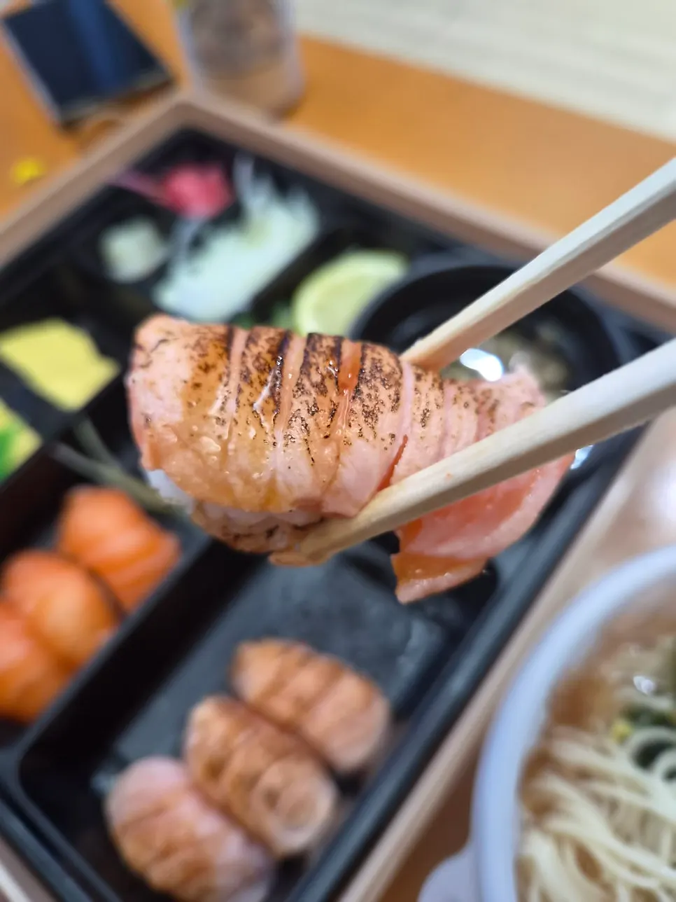 Digging into the sushi bento