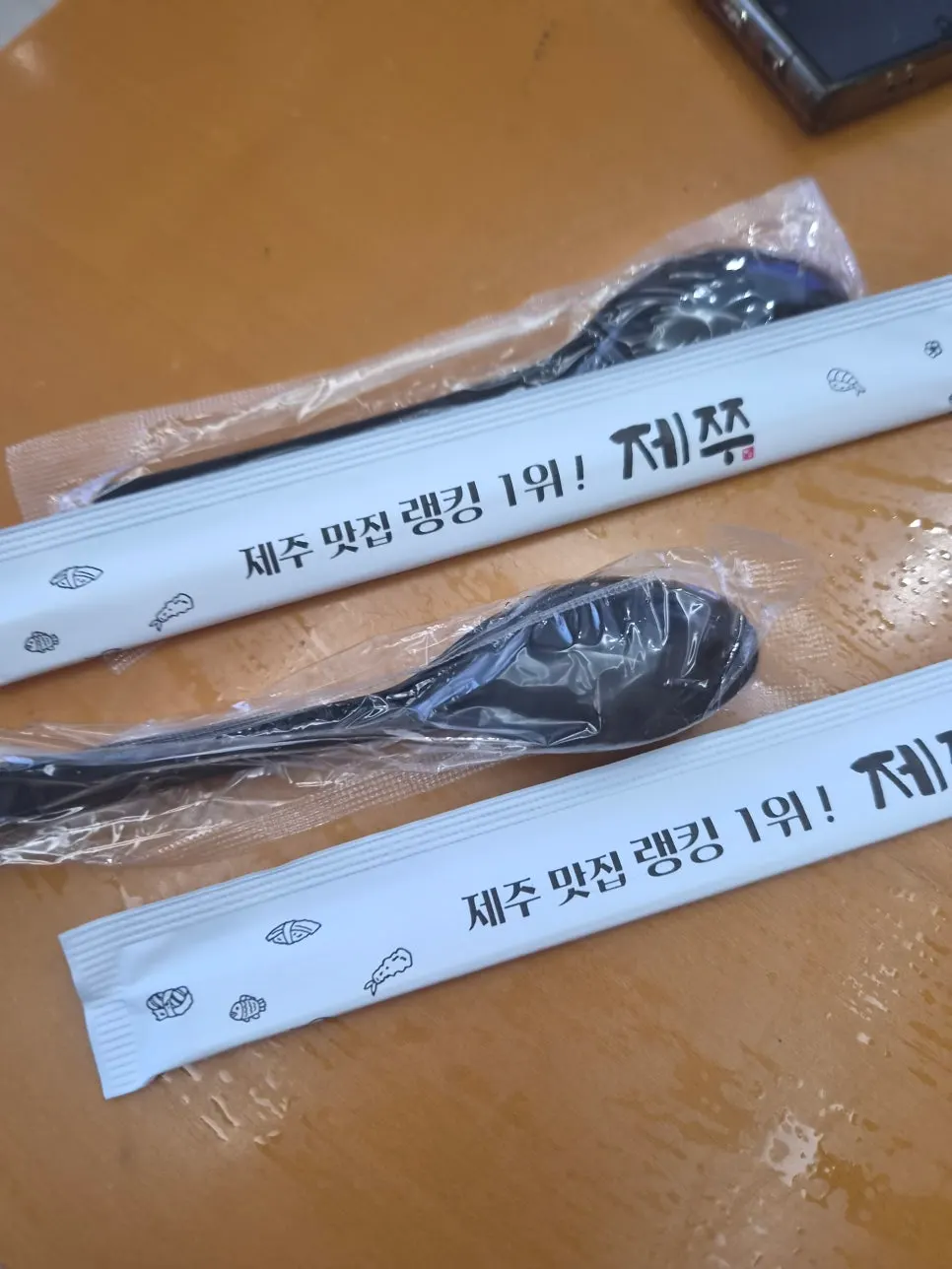 Lifting a bite of yeolmu naengguksu noodles