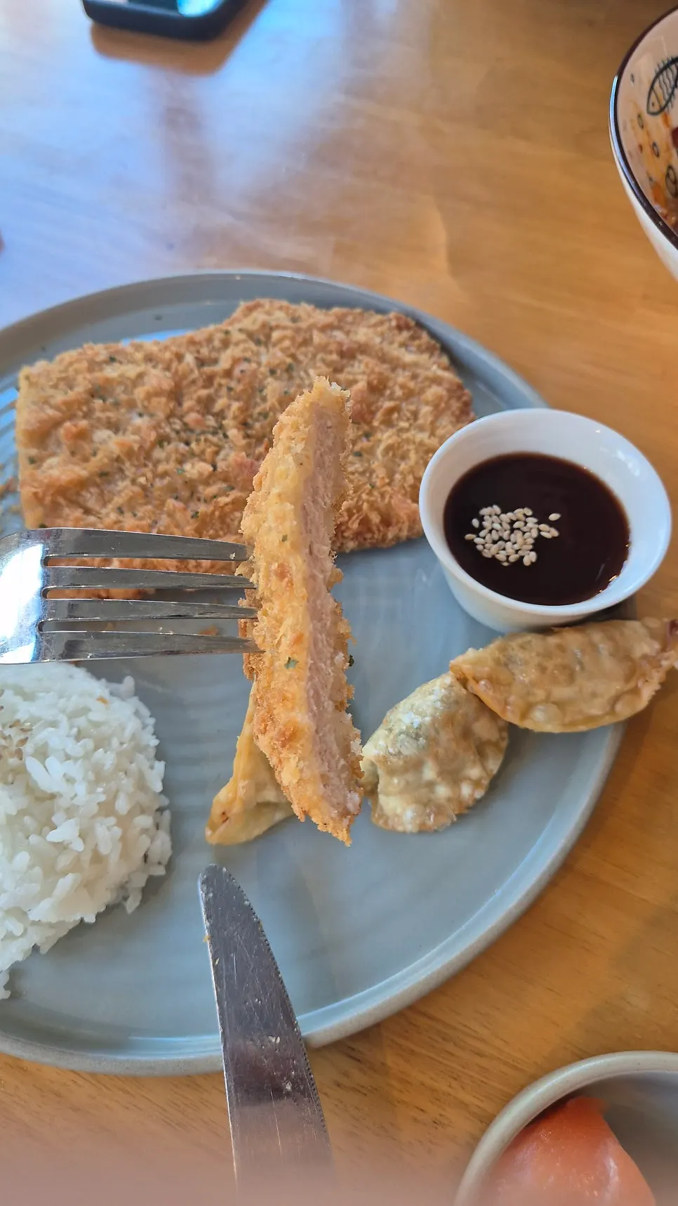 Jejju pork cutlet served with a fried dumpling