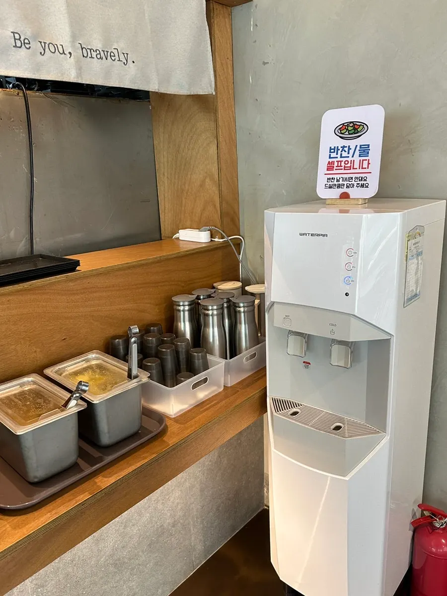 Water bottle and side dishes at the self-serve corner