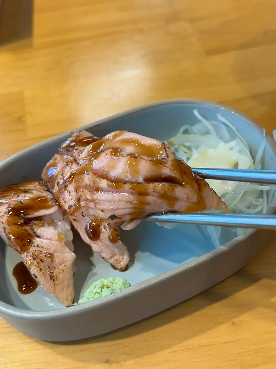 Close-up of grilled salmon sushi with a smoky finish