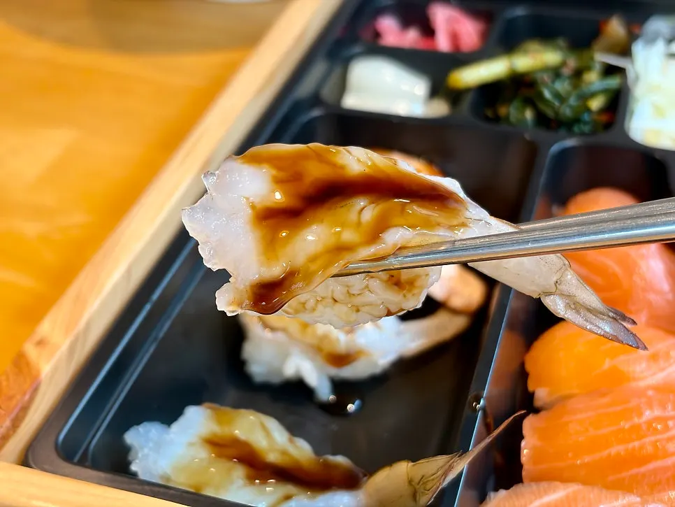 Sushi assortment including raw shrimp sushi