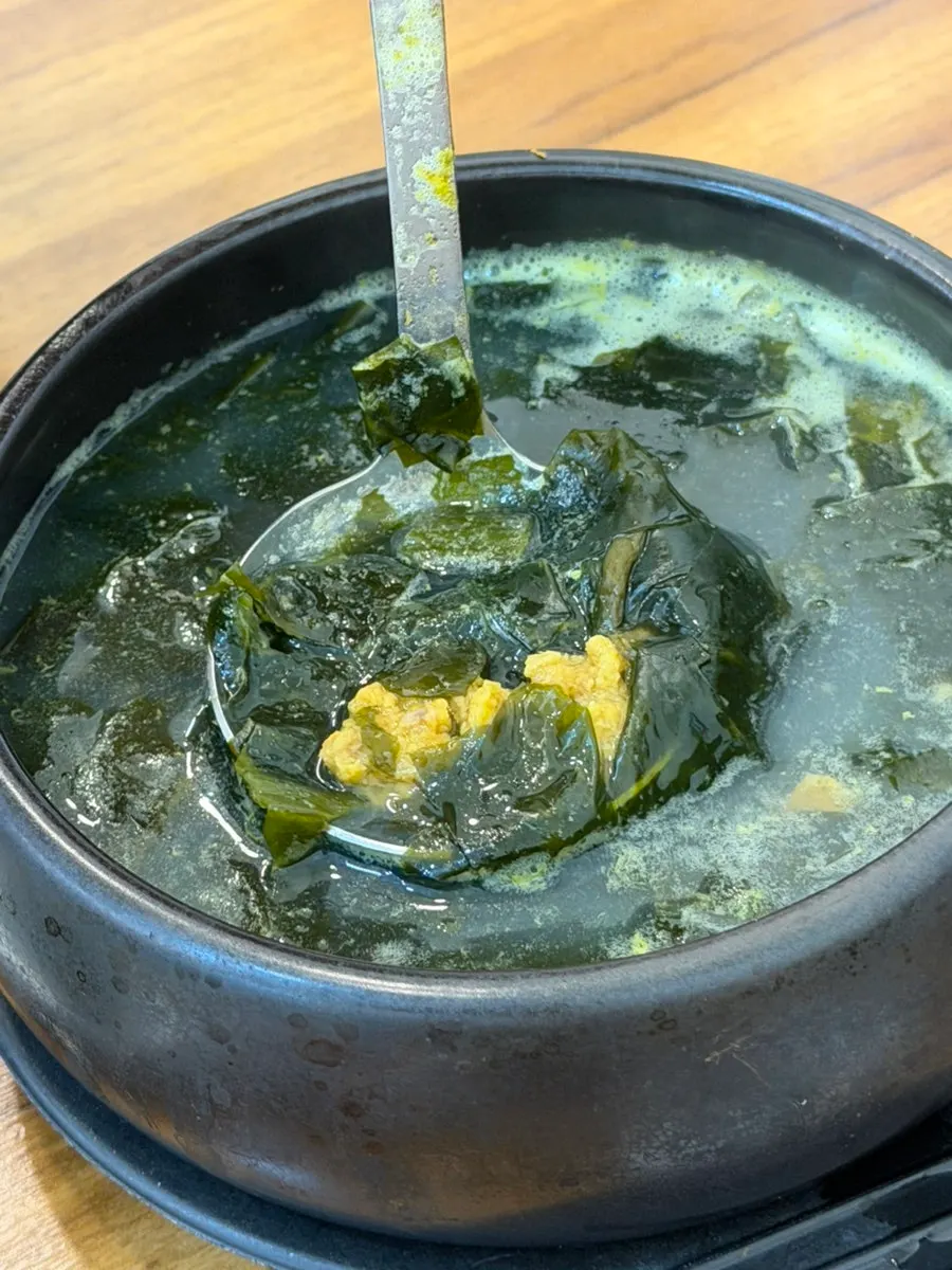A spoonful of seaweed soup with sea urchin roe
