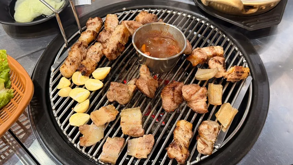 Grilled meat on the pan at a black pork restaurant in Andeok, Jeju