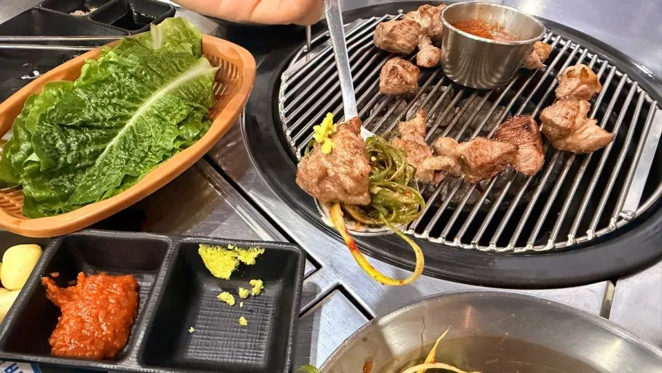 Picking up a piece of grilled black pork