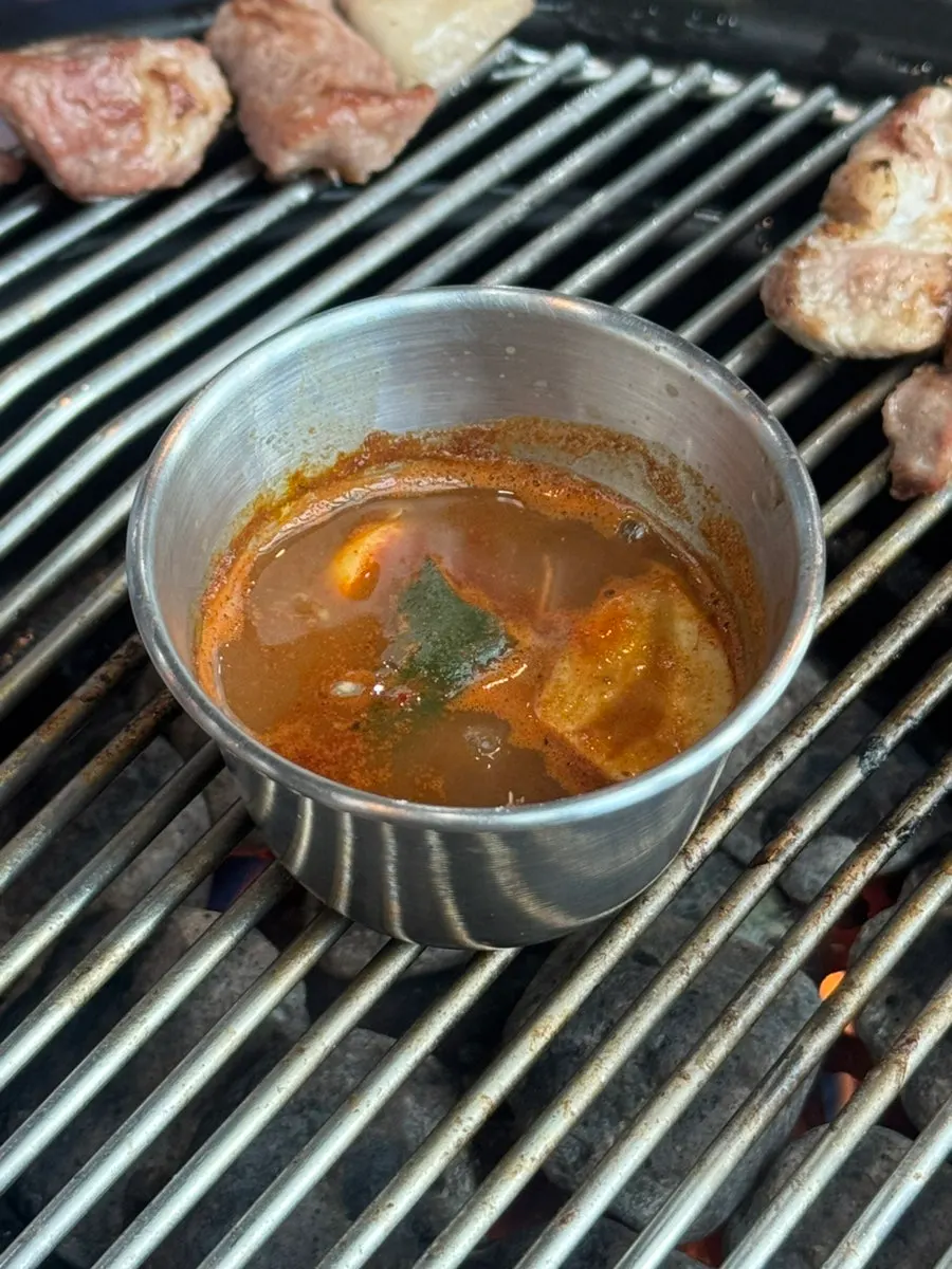 Meljeot sauce simmering with meat