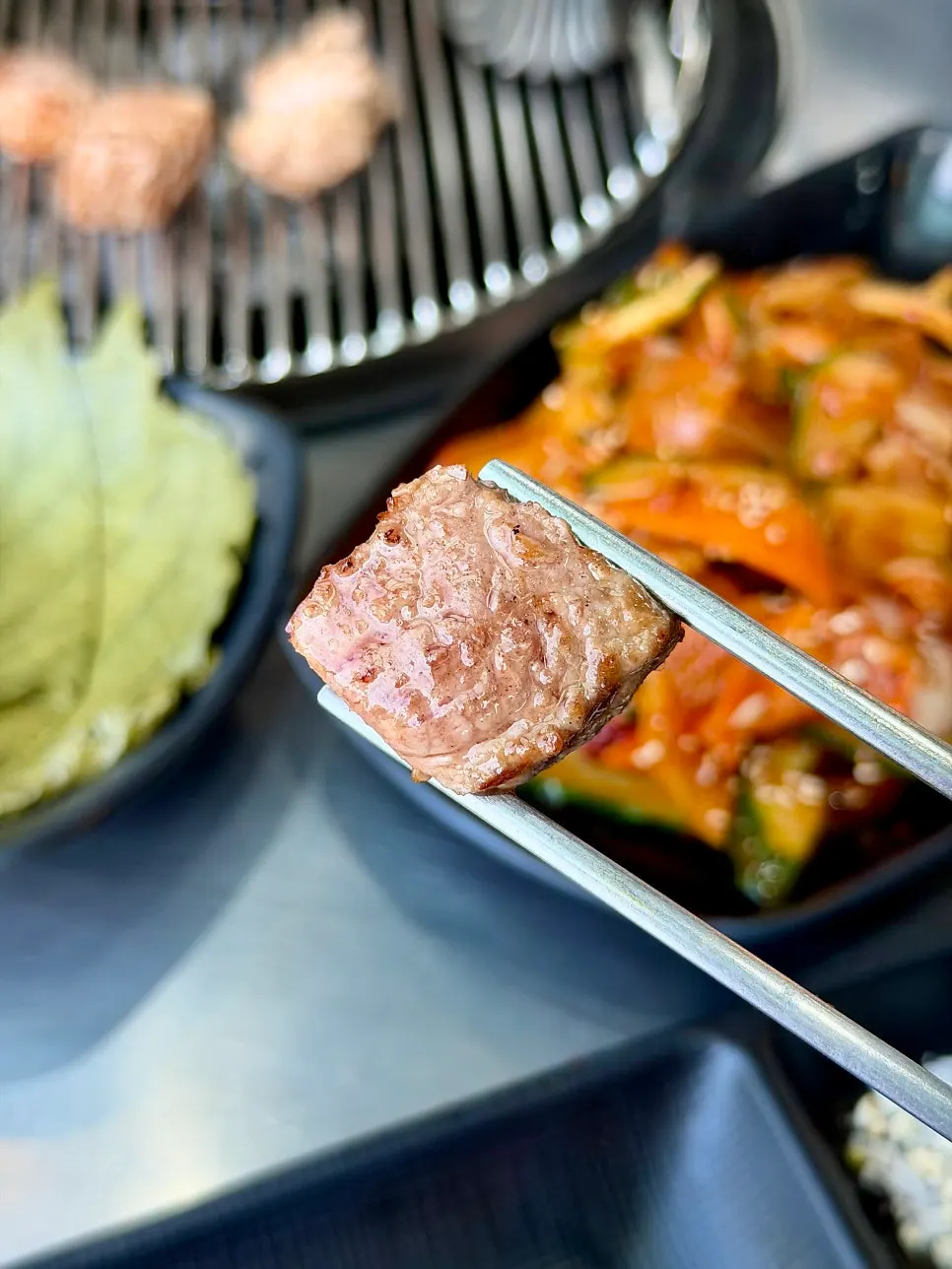 Black pork neck grilling over charcoal