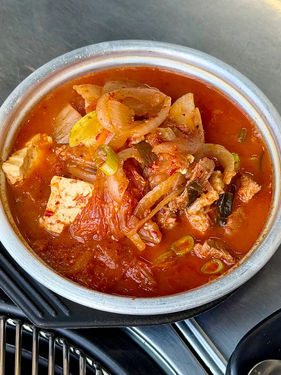Kimchi stew bubbling on the burner