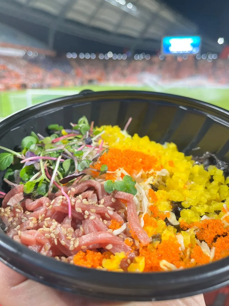 Eating a lunchbox in the away-game seating section