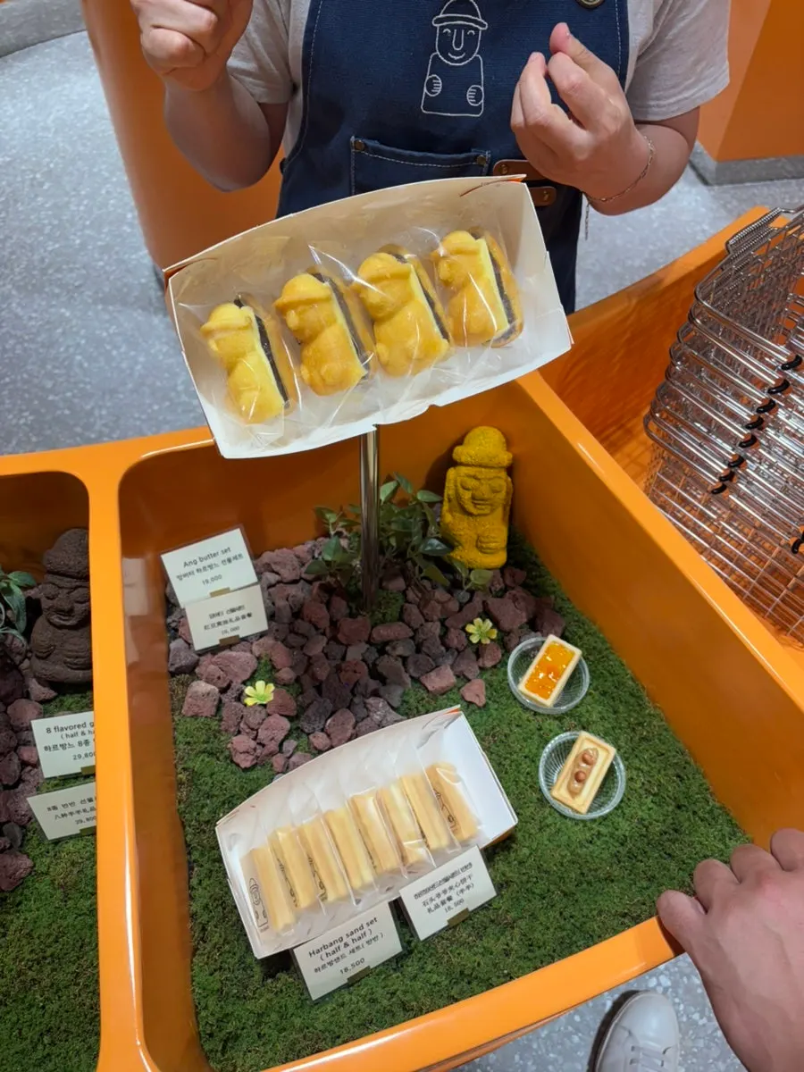 Interior of the Today Jeju store decorated in orange and basalt rock