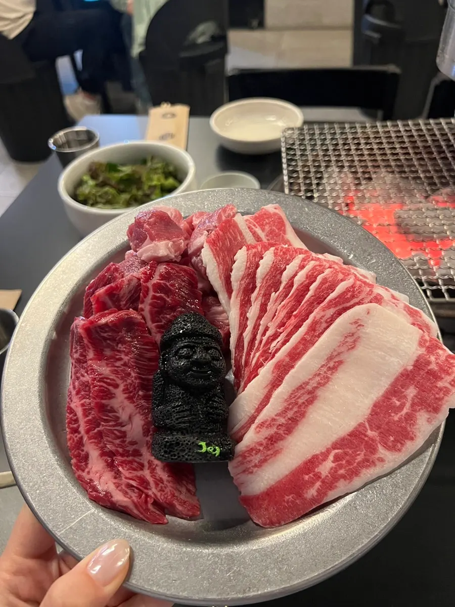 Table setup with brisket, hanwoo special cuts, and cubed black pork collar