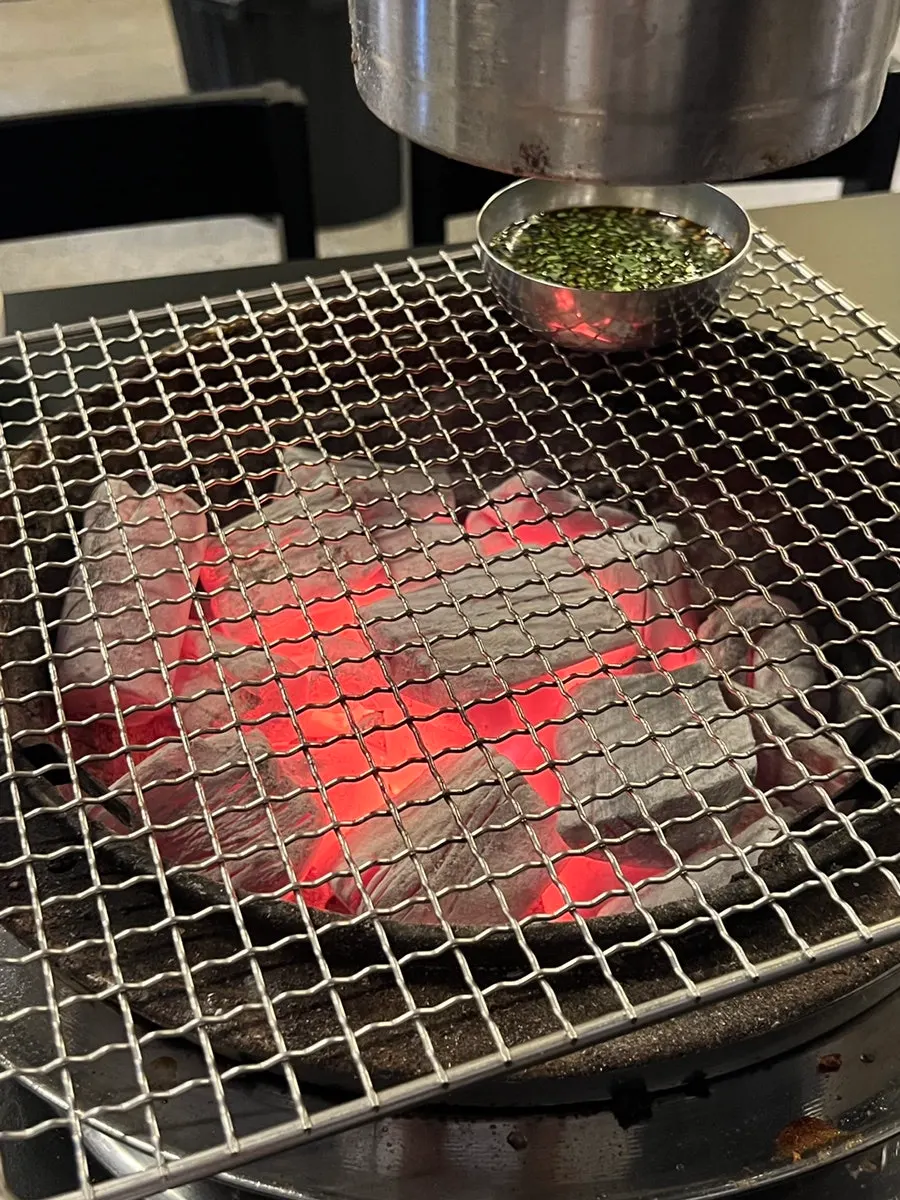 Meat on the grill next to a bowl of miyeokguk