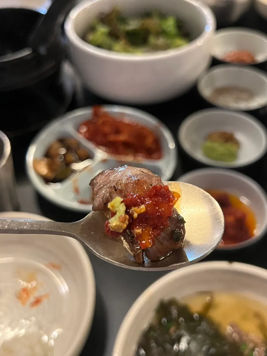 Meat dipped in the sauce combo recommended by staff