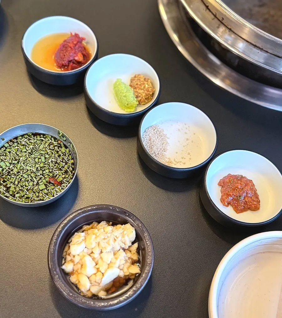 Side dishes and sauces set out before the meat arrives