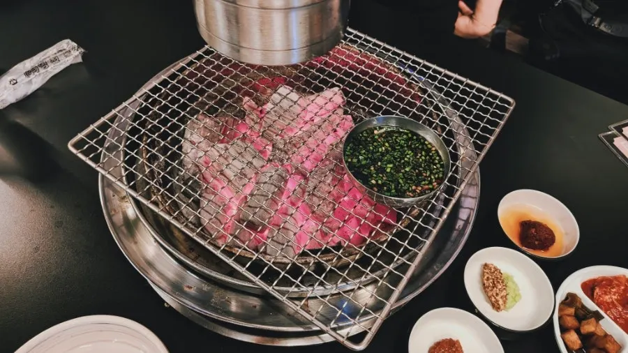 Wire mesh grill over hot red charcoal with garlic-chili soy sauce