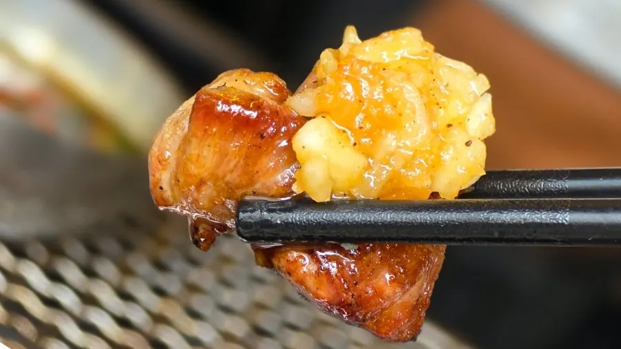 Cubed black pork jowl dipped in manong chili soy sauce