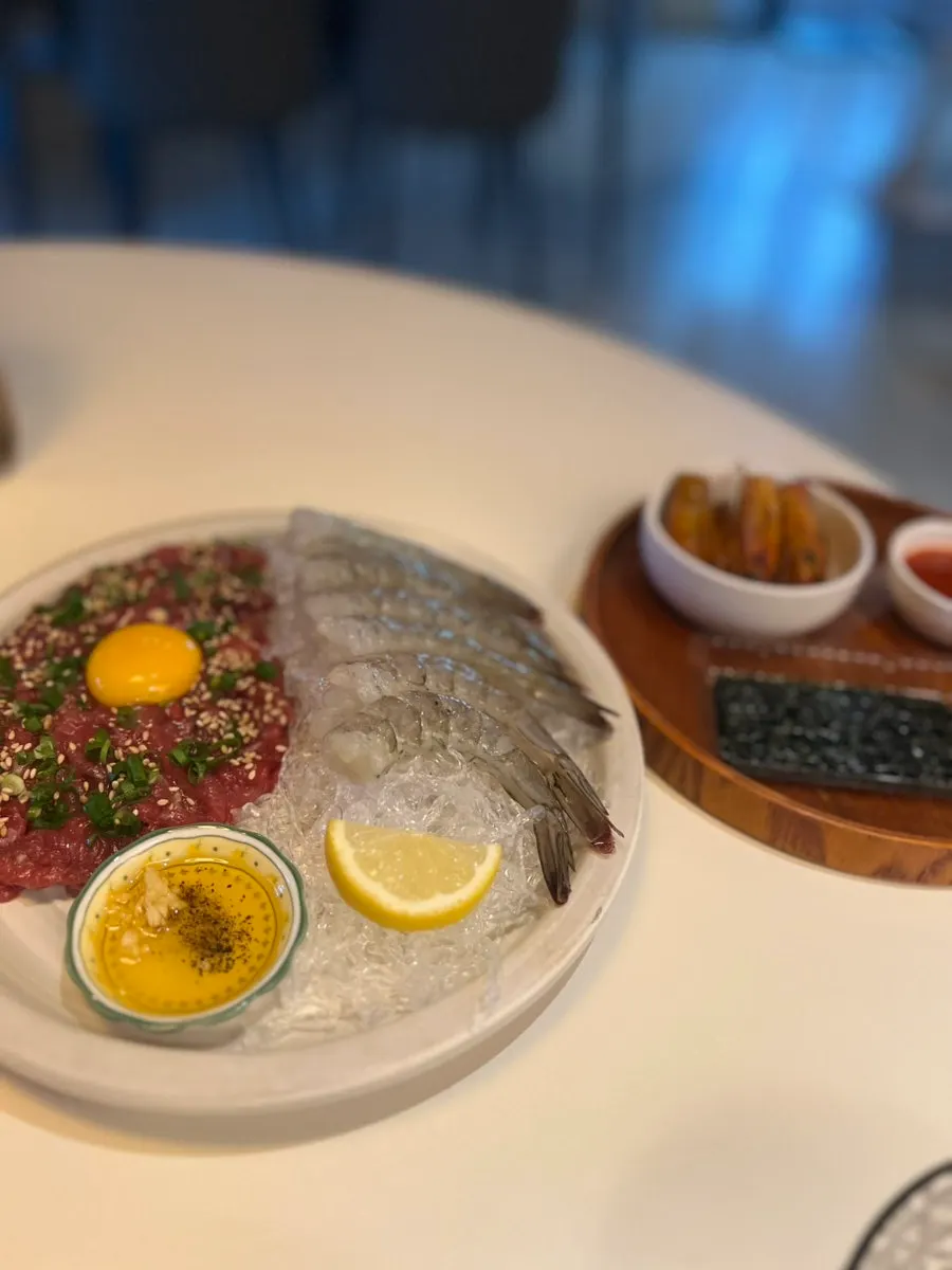Beef tartare and raw shrimp sashimi with fried shrimp heads and seaweed