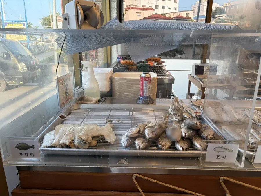 Grilled fish displayed near the entrance