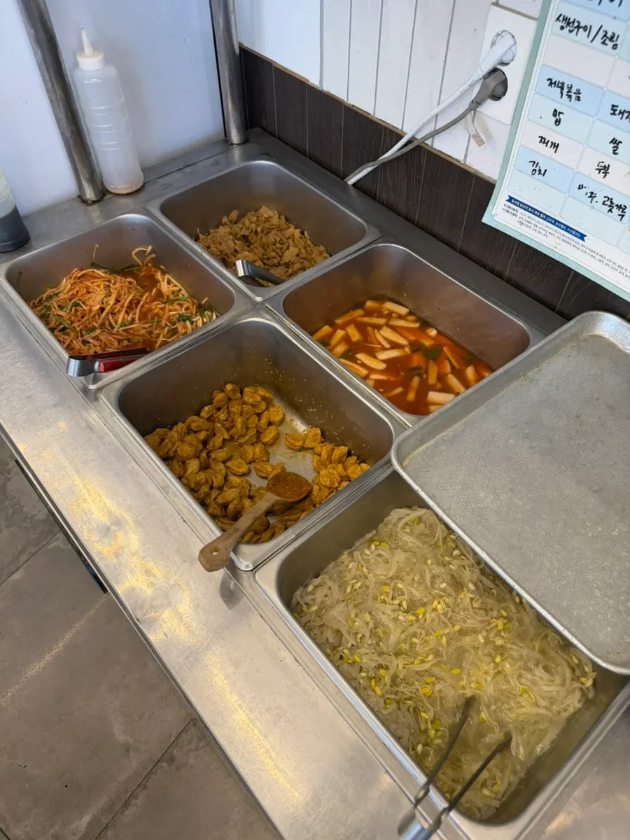 Plate of stir-fried fish cake and spicy radish salad among side dishes