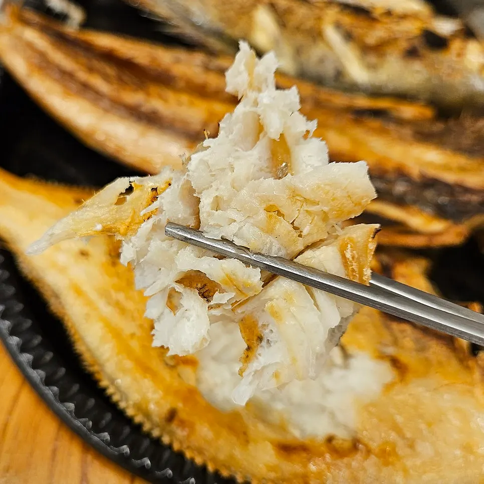Picked-apart flounder flesh with a spoonful of rice