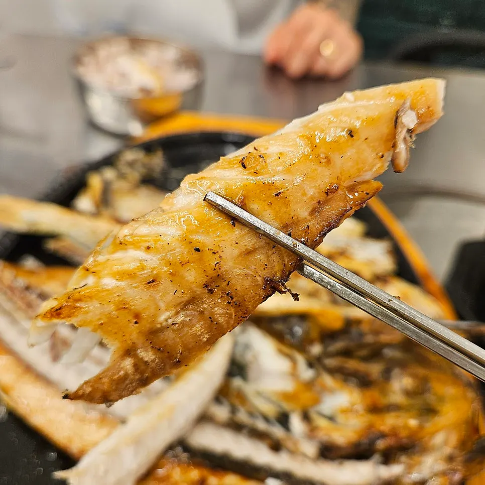 Golden-brown, directly charcoal-grilled mackerel