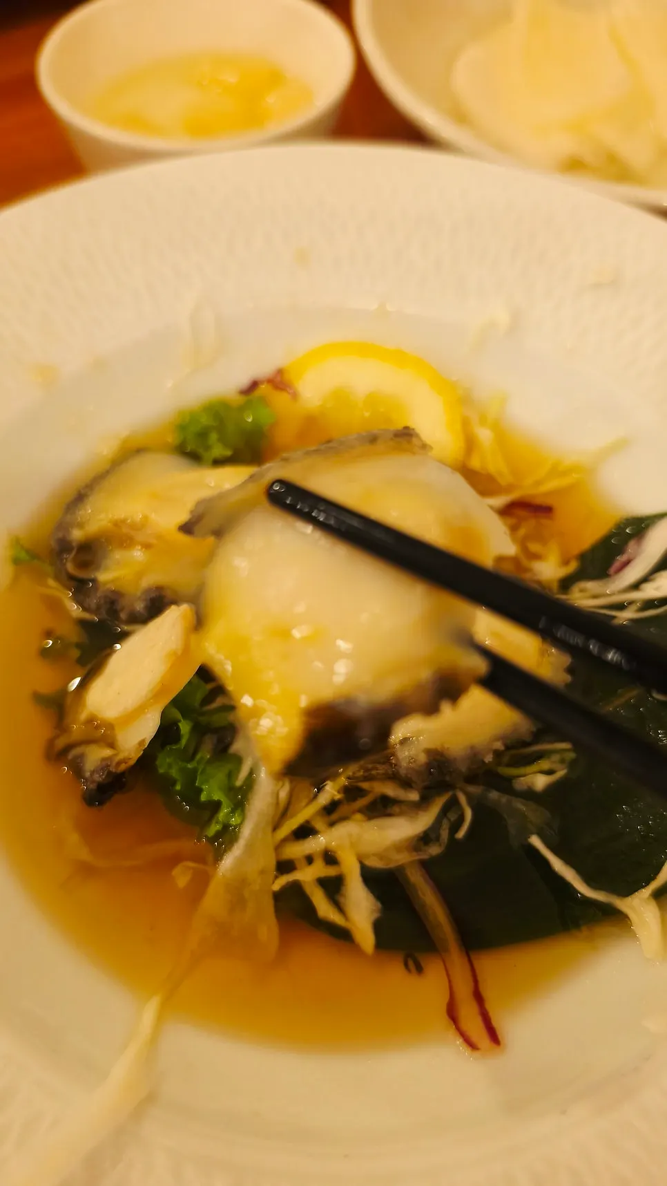 A piece of abalone dipped in entrail sauce
