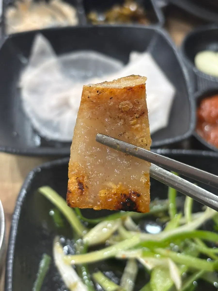 A chewy piece of grilled pork skin