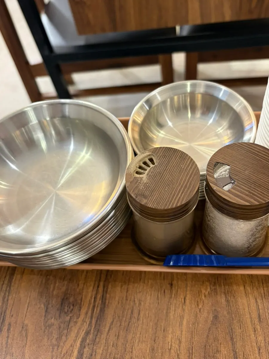 Small plates with salt and pepper set on the table