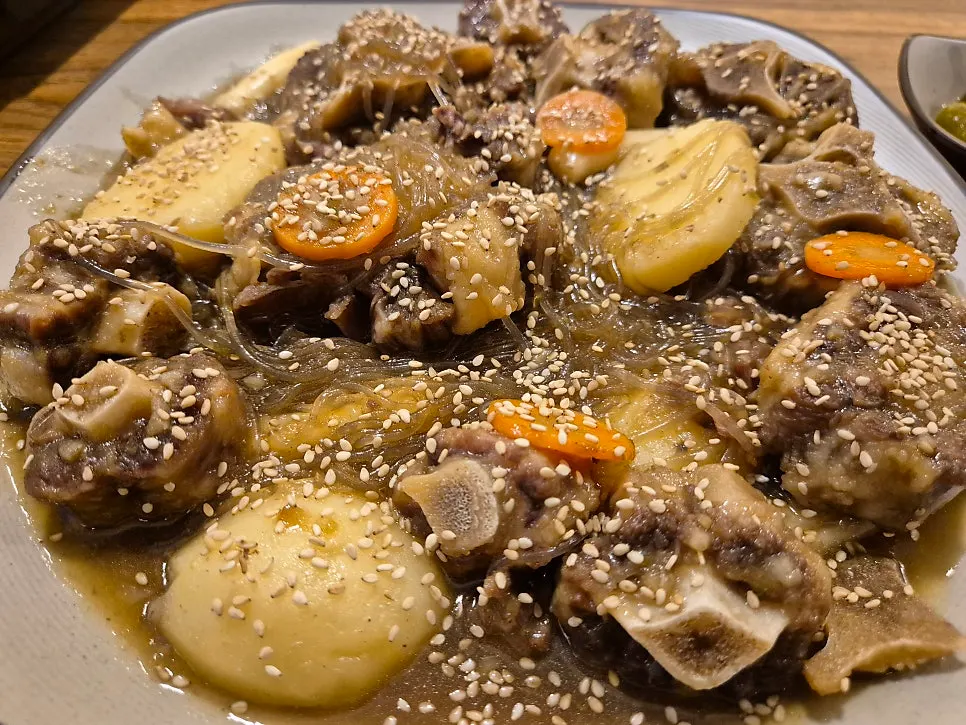 A generously plated serving of soy-braised oxtail stew