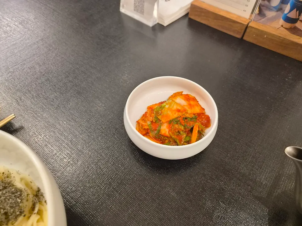 Table with Tanbaek's kalguksu and kimchi