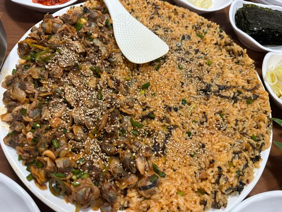 A plate of cockle bibimbap piled high with cockles
