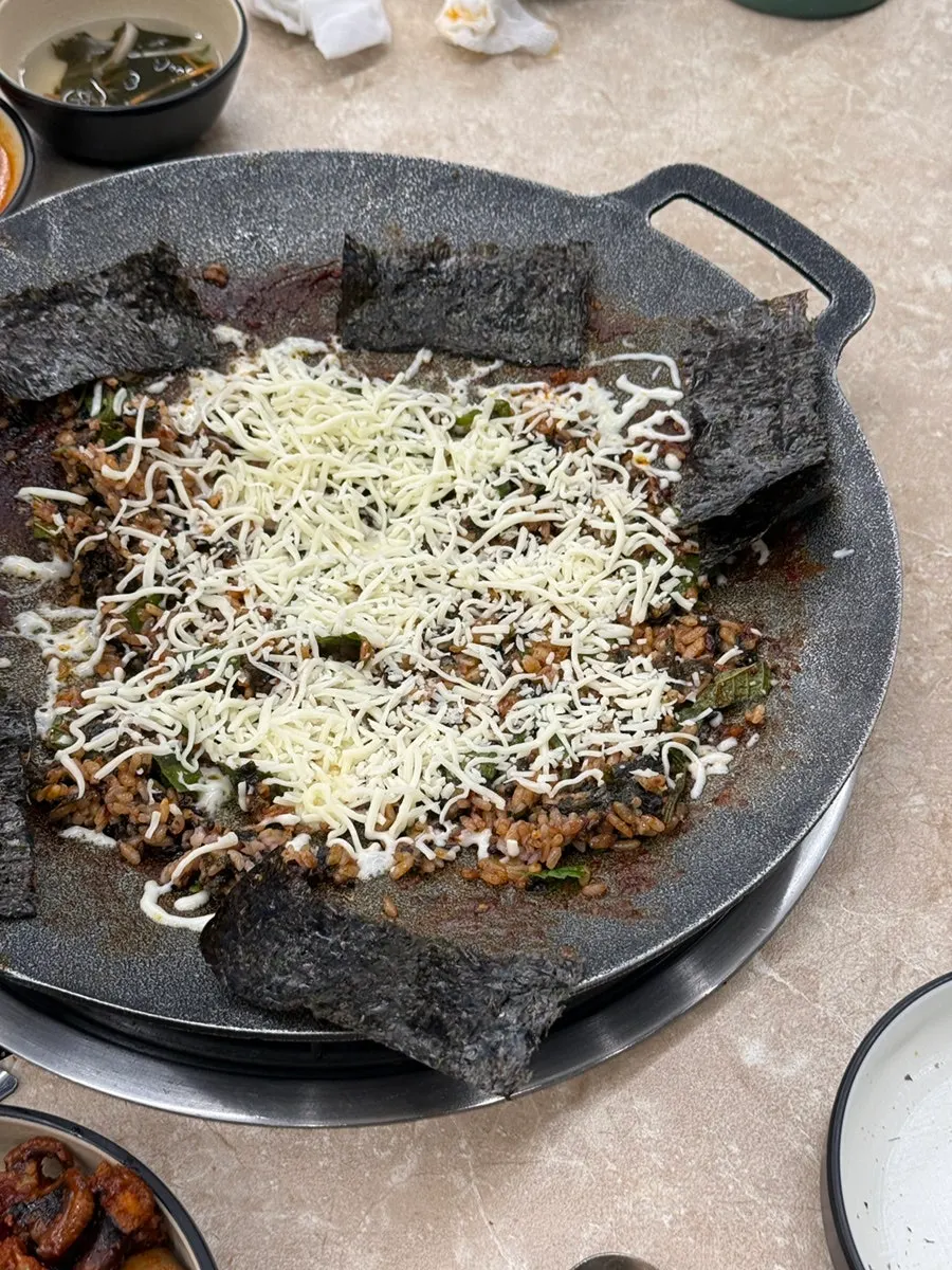 Snow cheese fried rice being stir-fried on the griddle