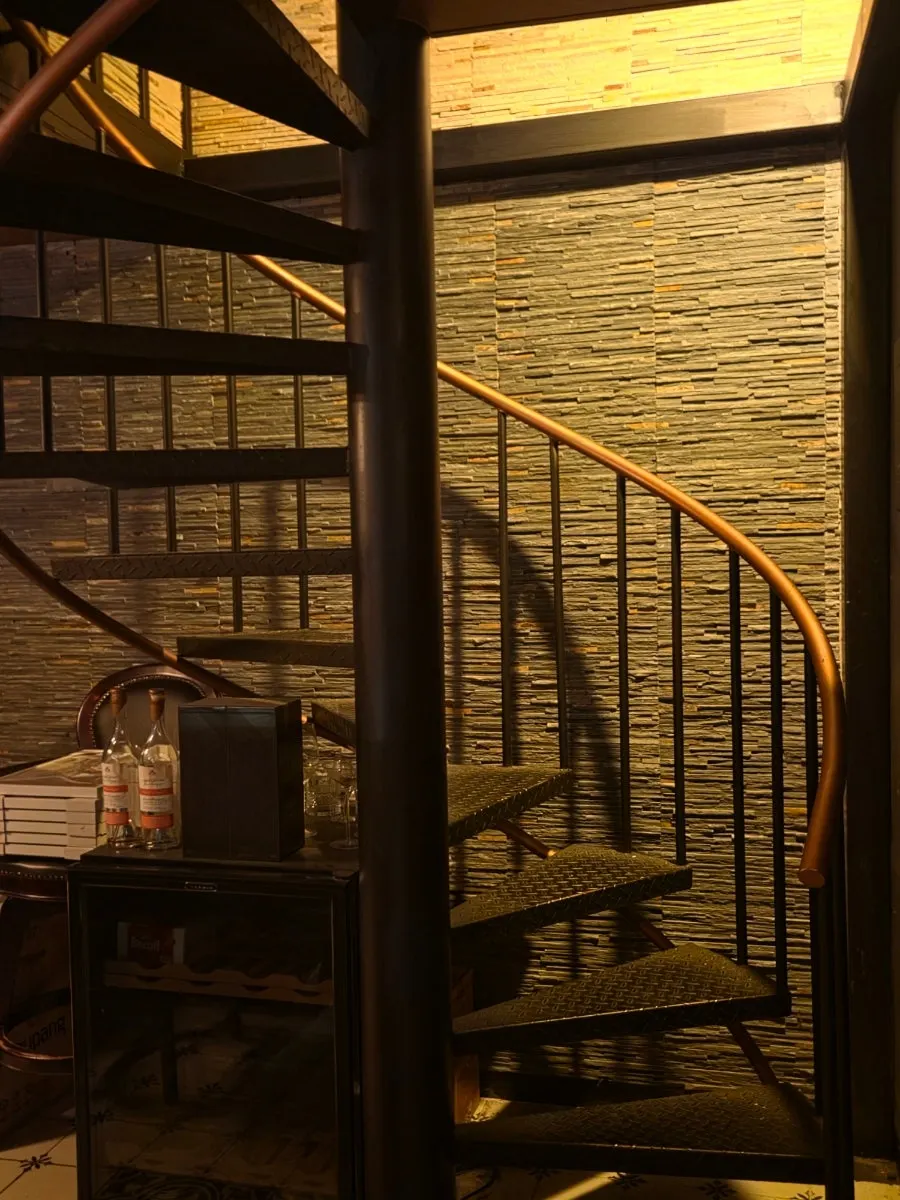 First-floor bar tables and spiral staircase