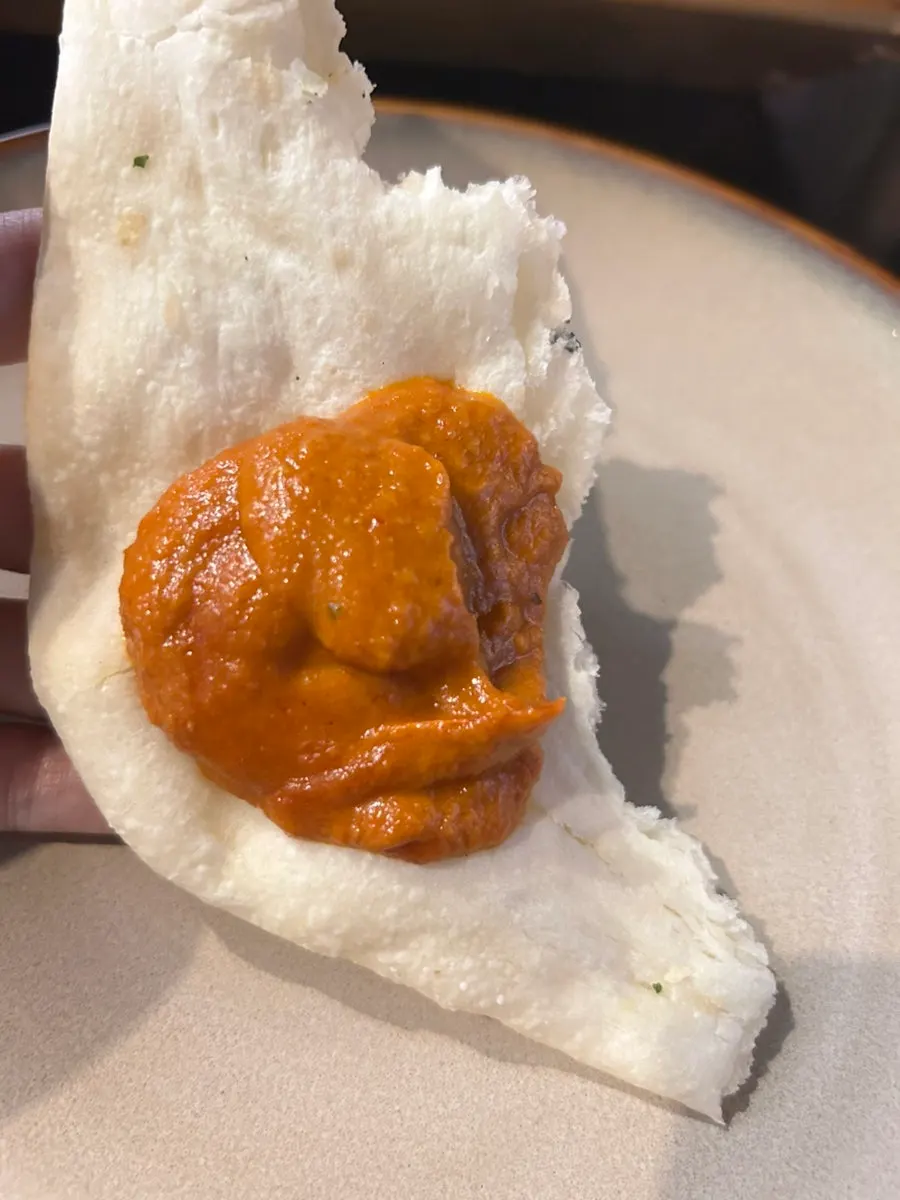 Shrimp makhani curry piled onto naan