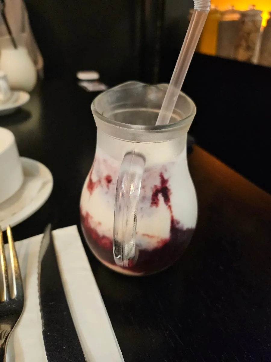 Two glasses of blueberry lassi and original lassi