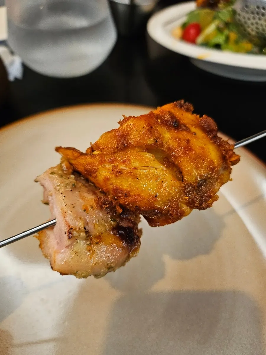 Close-up of tandoori chicken and salad dressing