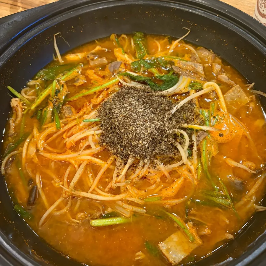 Spicy dessert lamb stew topped with ground perilla seed