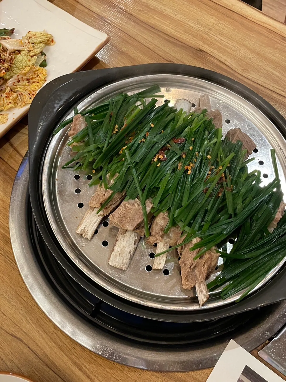 Boiled lamb rib set for two piled high with chives
