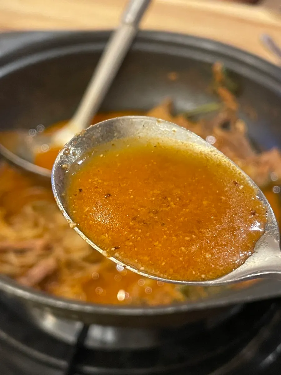 Broth from the hot pot packed with meat