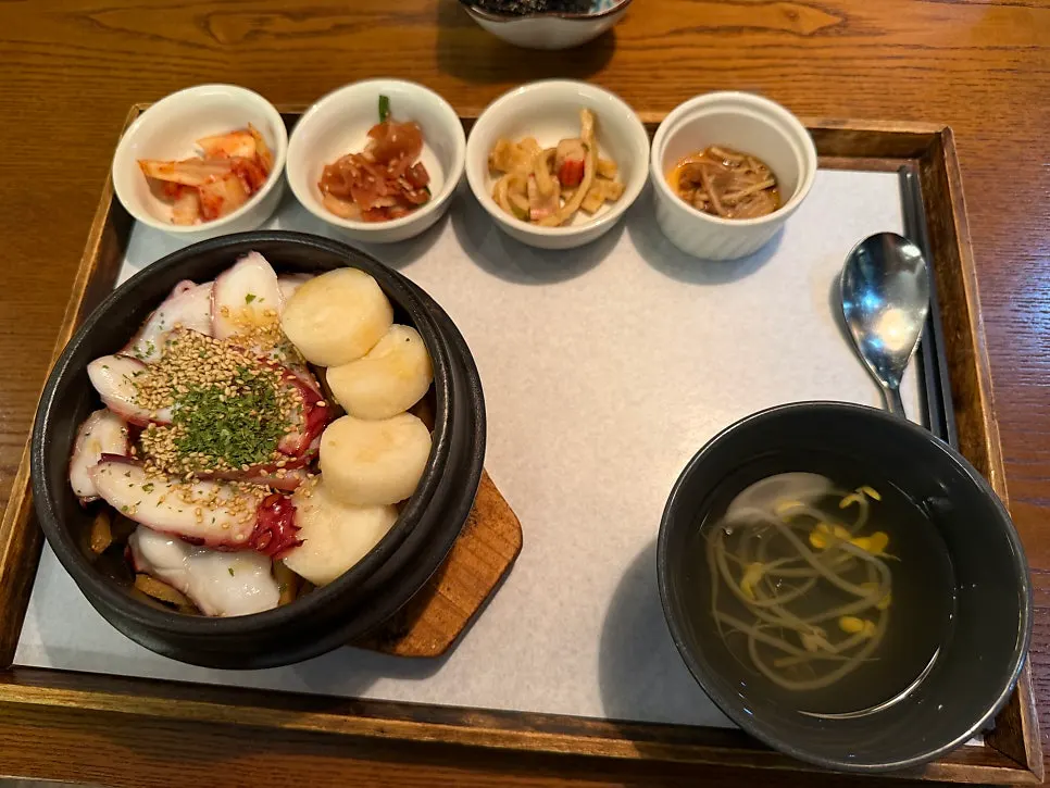 Octopus scallop sotbap table setting surrounded by banchan