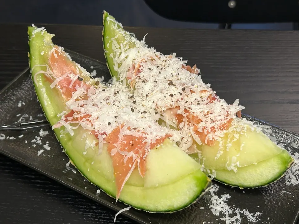 Melon topped with jamón and cheese