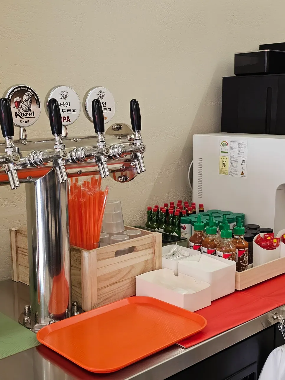 Self-service corner with hot sauce and ketchup at Roaster Burger