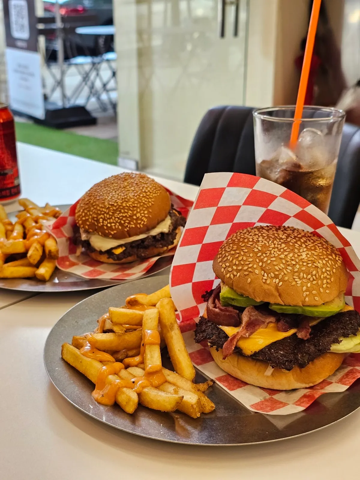 Full table spread with avocado burger and sauced fries set
