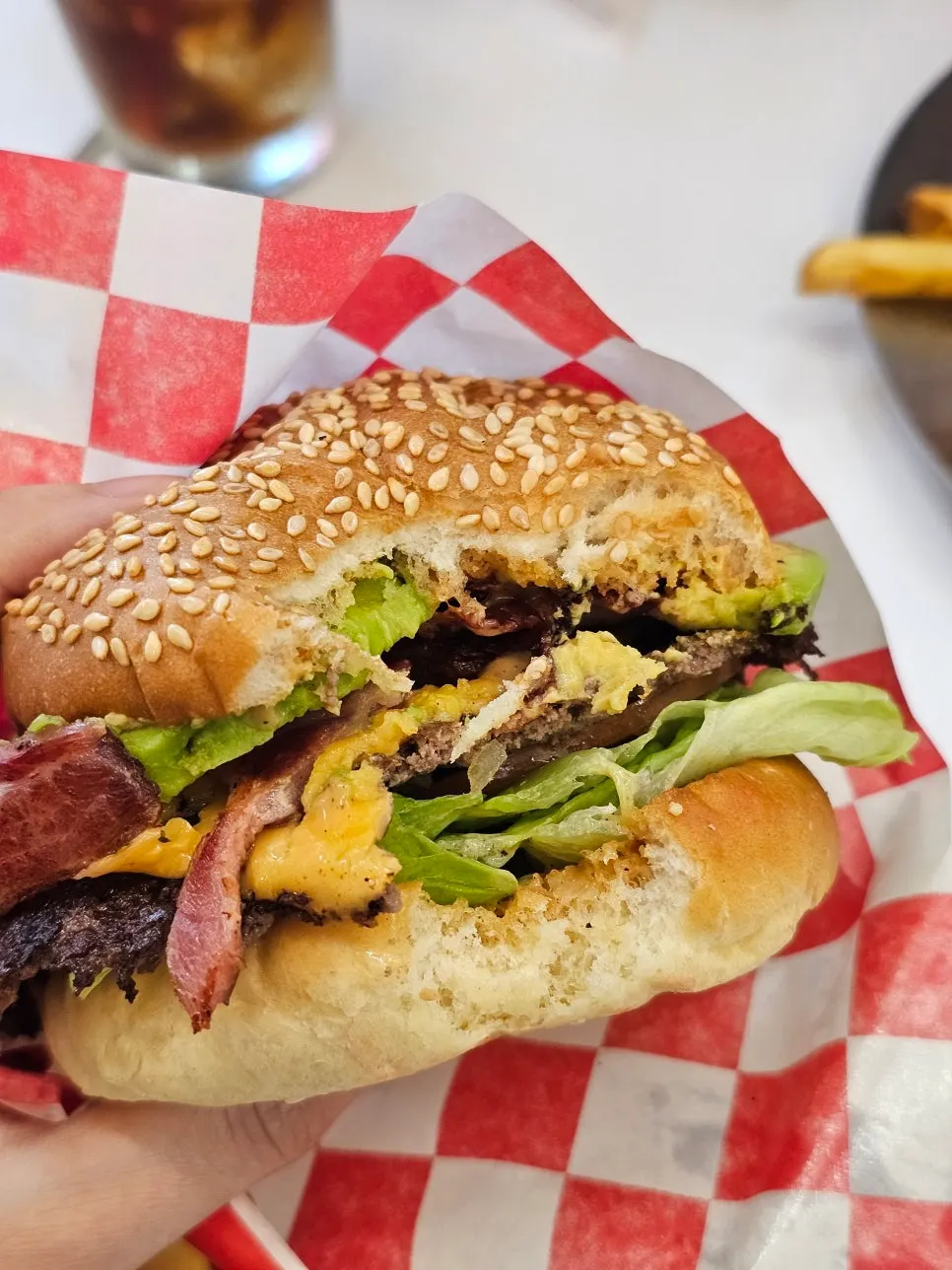 Avocado burger with a bite taken out, showing the ciabatta-like bun