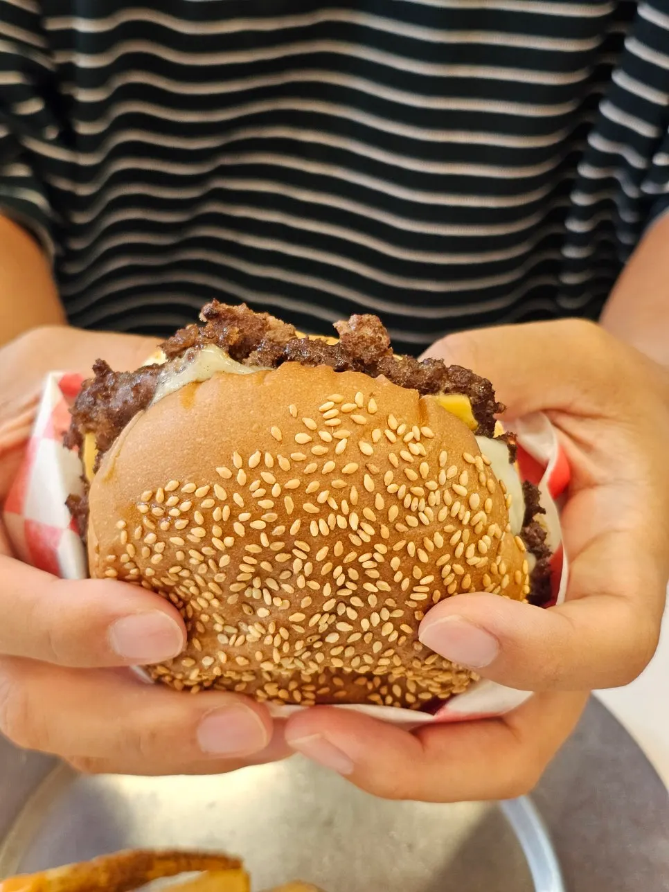 Handmade burger cut with a knife and fork