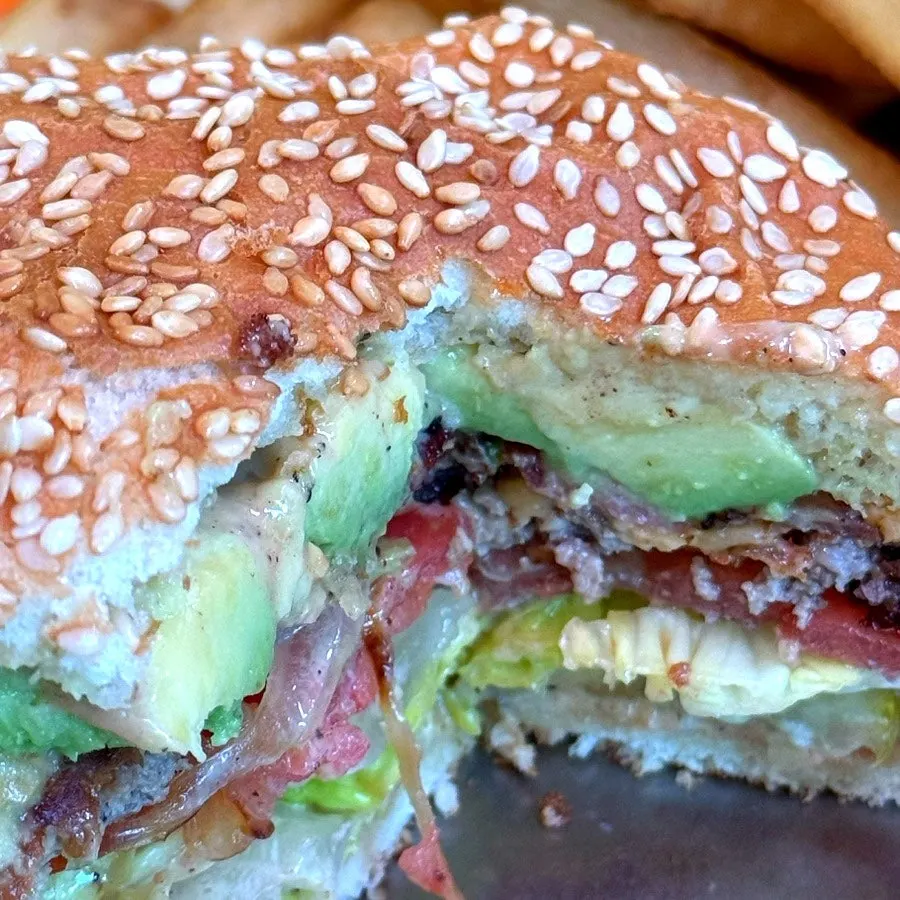 Burger with avocado and a juicy patty